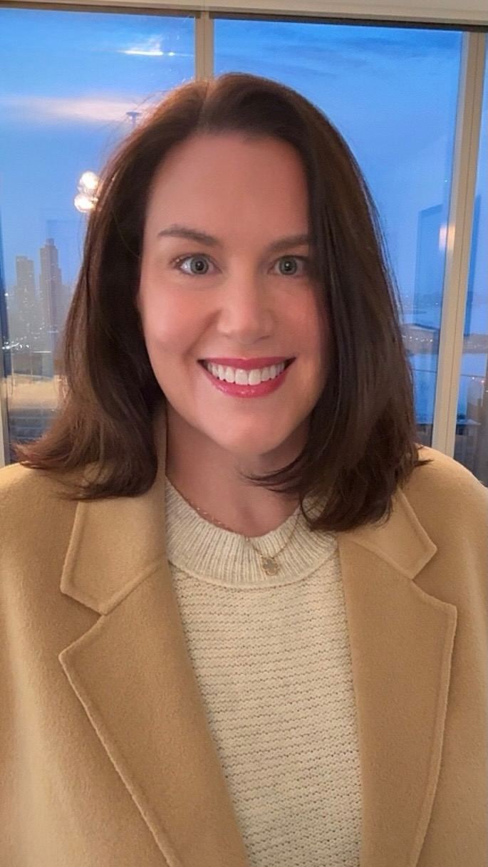 Jen in a camel coat at dusk