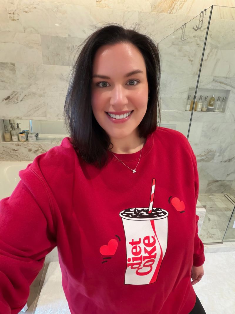 Jen in a red Diet Coke sweatshirt